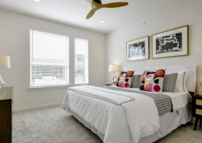 A bright and airy master bedroom with a large window, a walk-in closet, and an en-suite bathroom.