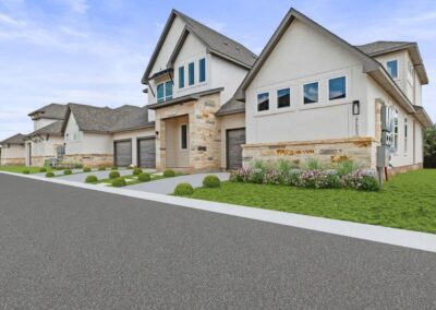 A collection of modern townhomes featuring contemporary architecture and well-maintained front lawns.