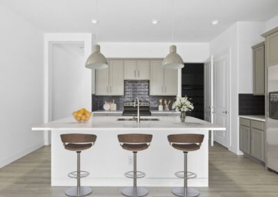A gourmet kitchen featuring custom cabinetry, a gas range, and a breakfast bar with seating.