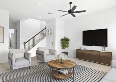 A spacious, open-concept living room with large windows and a view of the outdoors.