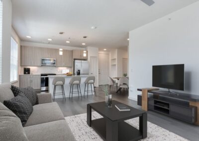 A spacious, modern living room with plush seating, high ceilings, and a large window.