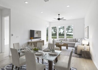 An elegant, modern dining room with a chandelier, wooden table, and chairs.
