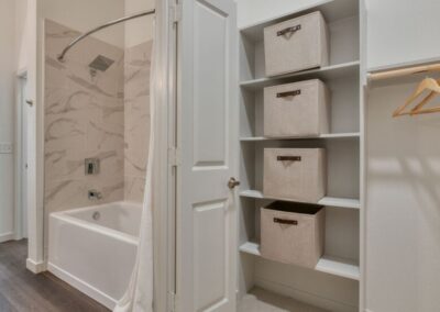 A luxurious en-suite bathroom featuring a double sink, and high-end fixtures.