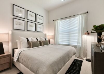 A well-lit bedroom with plenty of space, a ceiling fan, and a walk-in closet.
