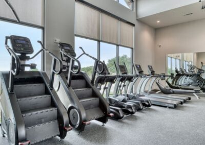 A professional 24-hour fitness center with a wide range of cardio equipment and free weights.
