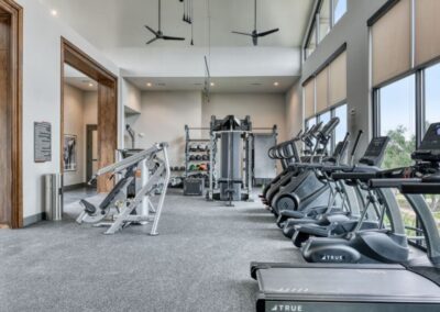The community gym featuring state-of-the-art machines, ample space for yoga, and strength training equipment.