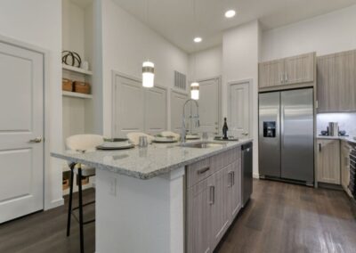 A gourmet kitchen featuring high-end stainless steel appliances, modern cabinetry, and granite countertops.