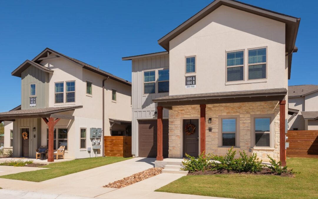 Luxury cottage-style townhome exterior with private driveway.