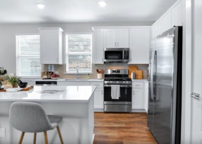Modern kitchen island with designer fixtures and custom shaker-style cabinetry.
