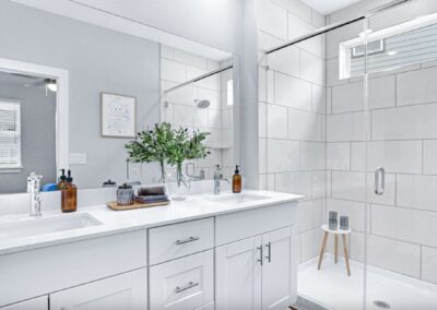 Modern bathroom featuring a glass-enclosed walk-in shower and designer hardware.