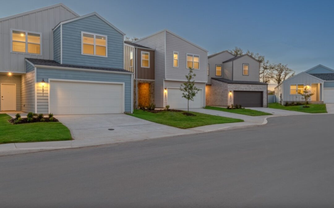 Contemporary architectural exterior showcasing stone accents and professional manicured landscaping.