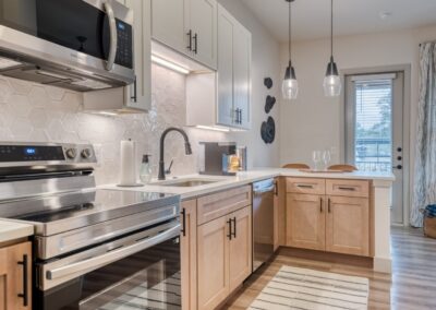 Gourmet kitchen equipped with Samsung stainless steel appliances and a farmhouse sink.