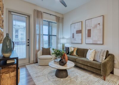 Spacious living area featuring floor-to-ceiling windows and matte black fixtures.