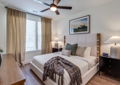 Sophisticated master bedroom retreat featuring high-end wood-style flooring at SA1352 in New Braunfels - Apartment Buddy