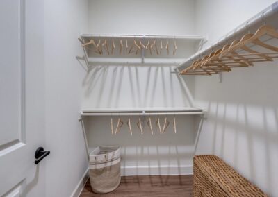 Expansive designer walk-in closet with custom built-in shelving at SA1352 in New Braunfels - Apartment Buddy